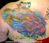 Sea Turtle swimming with Flamingo and Palm Trees on it's back Octopus pulling it down on back shoulder